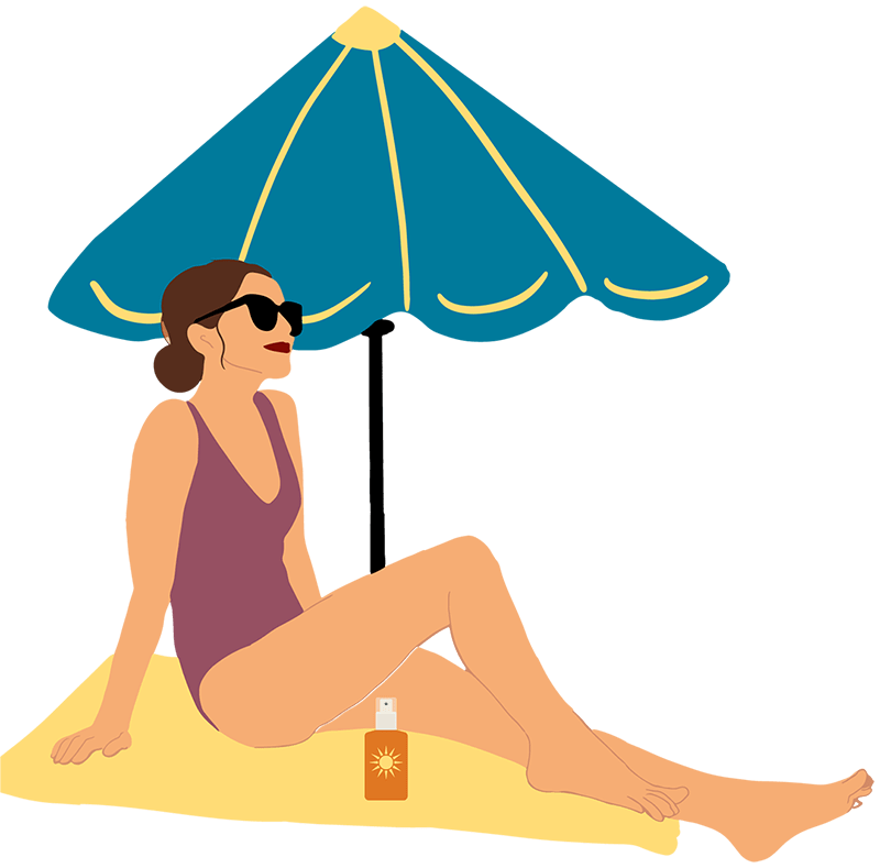 Woman on blanket with umbrella at the beach